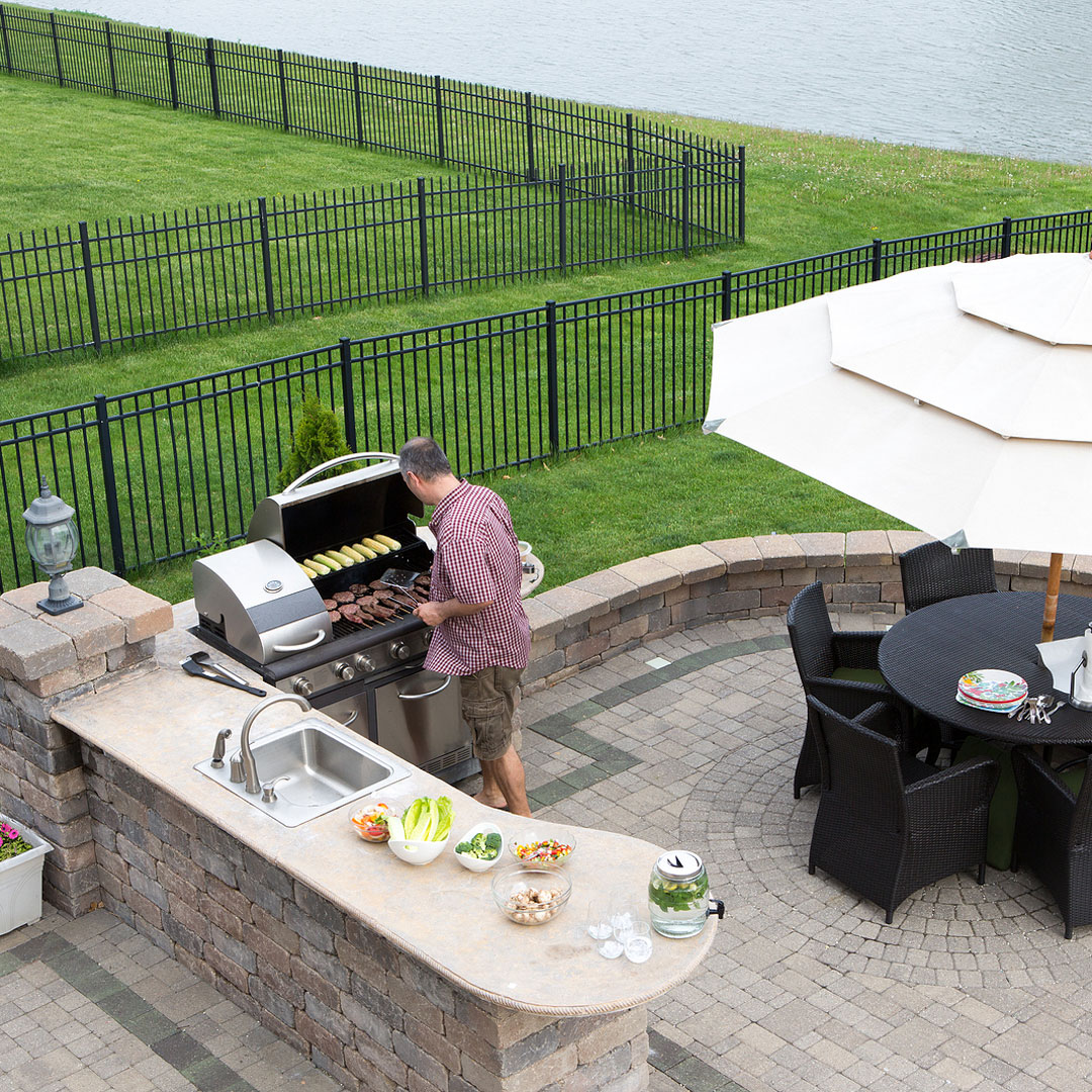 bigstock-Man-Cooking-Meat-On-A-Gas-Bbq-64841590 Outdoor kitchen installation in Grosse Royal Park and Birmingham MI