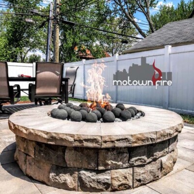 round back porch fire pit with large round stones